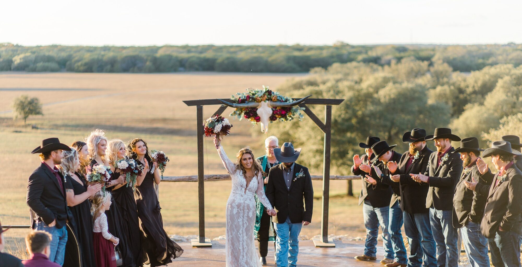 Wedding party celebrating the recessional at golden hour